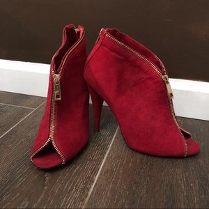Red suede booties with gold zipper detail